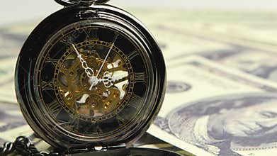 Watch skeleton on a background of money. Close up