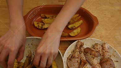 A woman prepares a chicken with potatoes in the oven. 4k