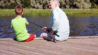 Grandfather and grandson fishing on river berth 18