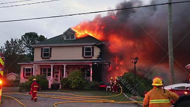 Firefighters battle blazing house fire.