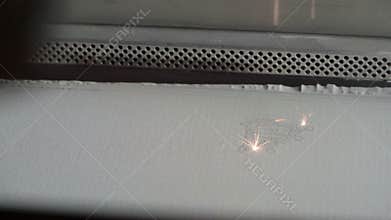 3D Printer during work. Selective laser sintering is an additive manufacturing technique that uses a laser as the power