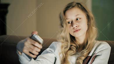Selfie girl. Child taking photo using smartphone