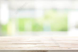 Wood table top on blur white green kitchen window background