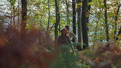 Beautiful couple on a hike through the woods in autumn colours