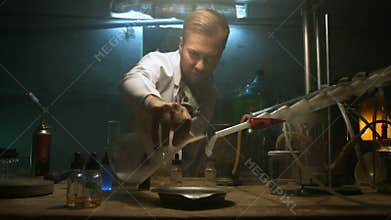 The scientist collects gas in the flask after the experiment