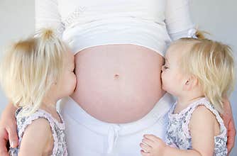 Girls Kissing Mom's Belly