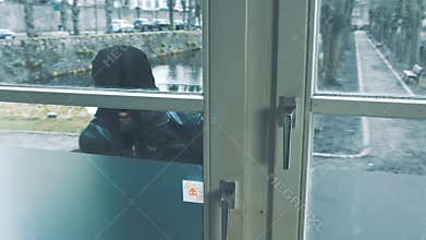 Burglar with crowbar break door to enter the house