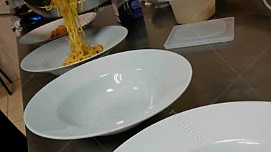 Cook preparing pasta.