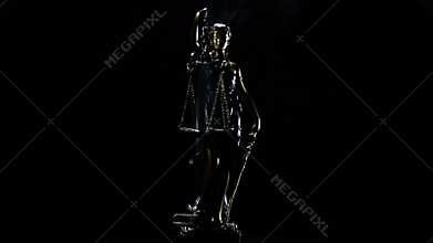 Lady justice in rotation over black background with strands of smoke