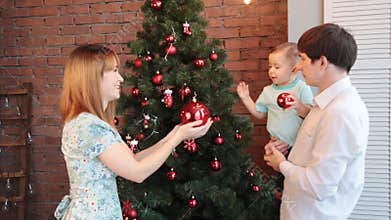 Happy Family Decorating Christmas Tree