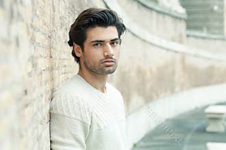 Street handsome man, urban style. Leaning on a wall. Outdoor