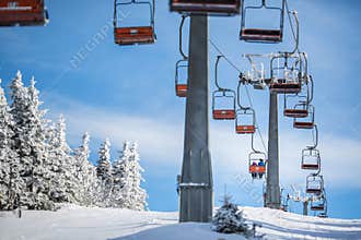 Ski lift with skiers being carried up the hill