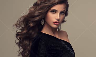 Beautiful model with long, dense and curly hairstyle.