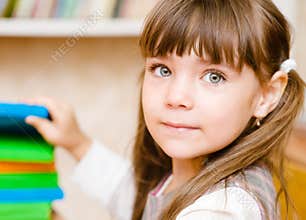 Young schoolgirl takes a book