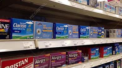 Woman buying Claritin allergy medicine