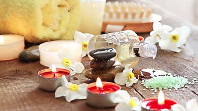 Spa still life of rocks, bath salt, massage oil and flowers