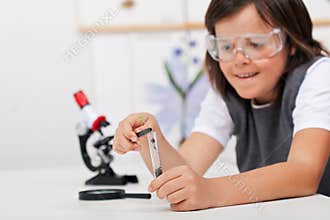 Young boy study plant in biology class