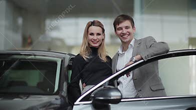 Young couple rejoicing buying a car