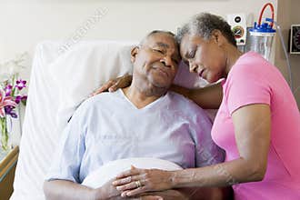 Senior Couple Embracing In Hospital