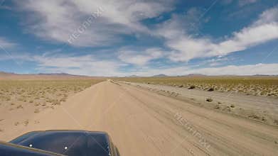 Front view of off road vehicle driving in the Atacama desert