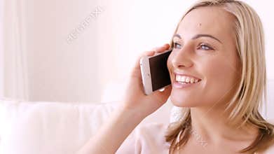 Blonde woman smiling and calling on the phone
