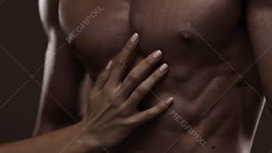 Athletic torso and woman hand