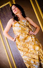 Stylish woman in gold dress