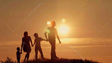 Happy family on sunset silhouette
