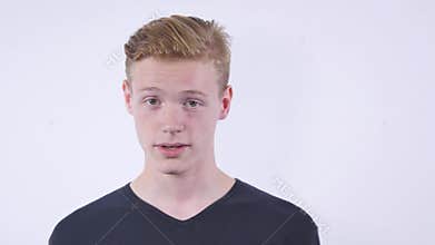 Close up portrait of cute teen boy looking aside with hand on face.Isolated on white background.