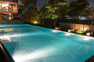 Peaceful pool reflections in the evening twilight with warm still water filled to the brim and ready for swimming. Bright mood l