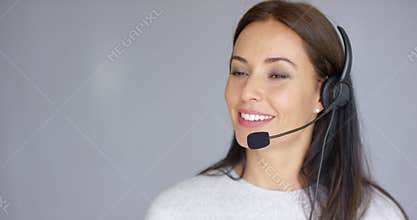 Adorable call center agent speaking with someone on headset