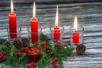 Christmas candles on a wooden background