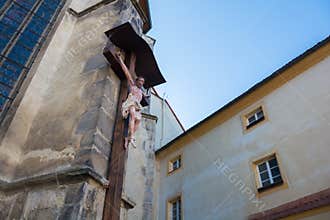 Wooden statue of Jesus on the cross on gothic church in Cheb