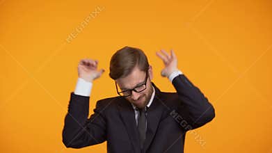 Self-confident business man dancing, celebrating promotion, career growth