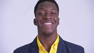 Face of young happy African businessman nodding head yes