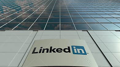 Signage board with LinkedIn logo. Modern office building facade time lapse. Editorial 3D rendering