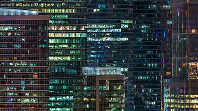 Modern office building with glowing windows at night timelapse. Moscow city