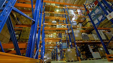 Many warehouse racking rows with numerical signs.