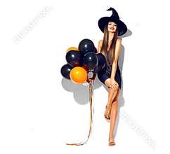 Halloween party girl. witch holding black and orange air balloons