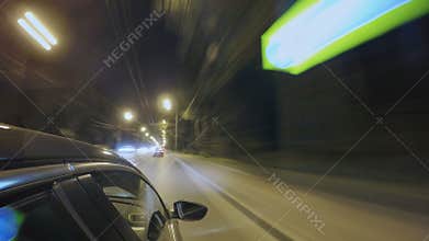 Driving in night city street. Blurred timelapse. View from outside of the cabin