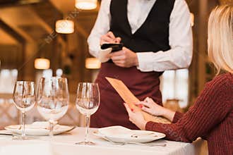 Waiter writing down the order of customer