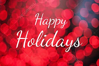 Text Happy Holidays on red lights bokeh background.