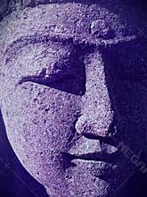 Closeup of Indian woman statue face with closed eyes and ultraviolet shadows
