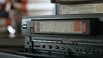 VHS cassette ejecting from video cassette recorder.