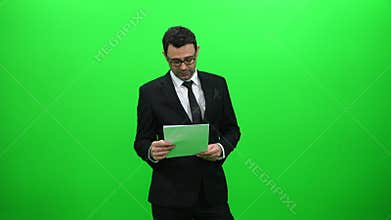 Male news anchor presenting on green screen