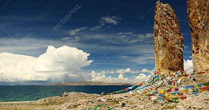 4k Prayer flags at the lake namtso in tibet,ancient monk meditation in cave.