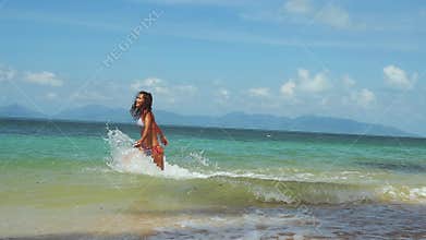 Joyful young pretty woman in bikini running into the sea on sunny summer day. slow motion. 1920x1080