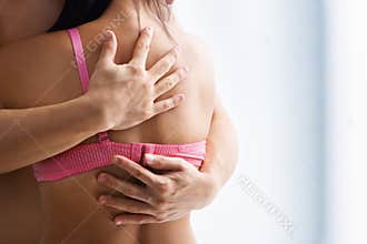 Hand supporting breast cancer victim