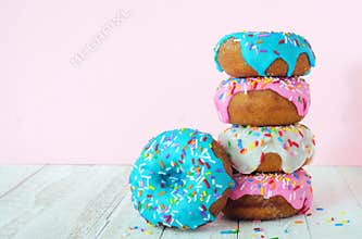 Stack of donuts on a soft pink background