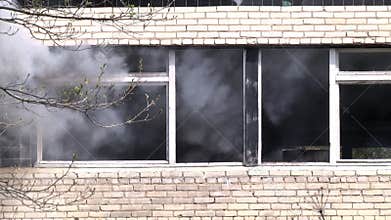 Military hand grenade explosion on background of destroyed house.